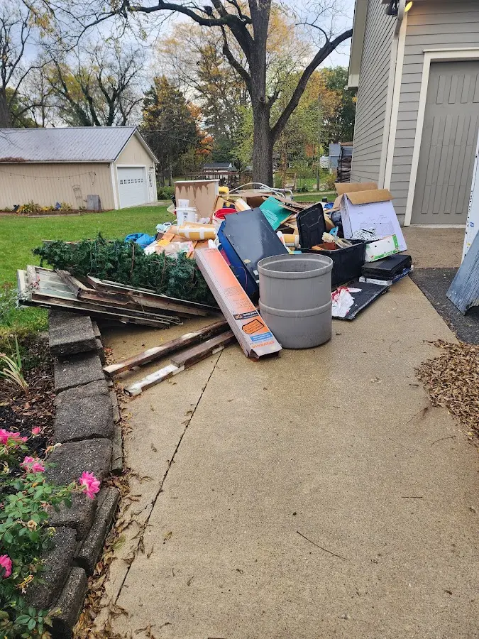 Dumpster being loaded with debris for Commercial Dumpster Rental in Lander